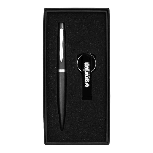 A black pen and bottle opener keyring set nestled in a black gift box with a branded logo.