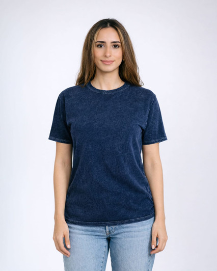 A woman models a navy blue Colortone® Mineral Wash adult t-shirt. The shirt has a rounded neckline and short sleeves.