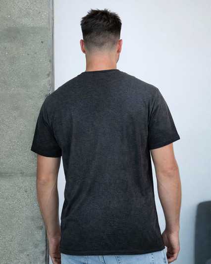 A dark charcoal grey t-shirt with a simple design, shown from the back on a model against a plain background.
