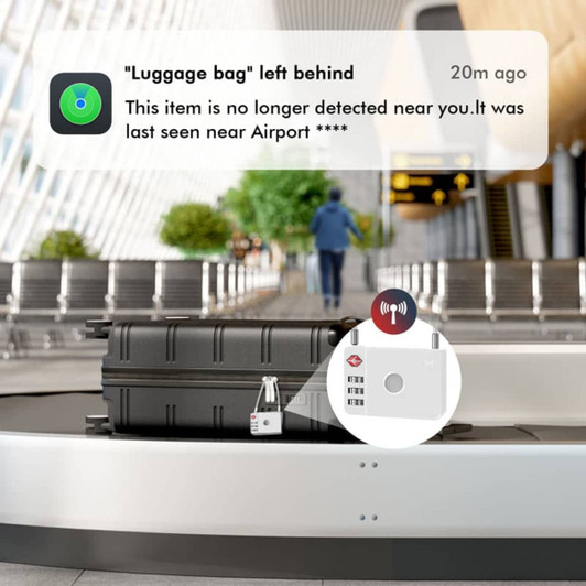 A luggage lock in silver is attached to a black suitcase on a baggage carousel. The setting is an airport terminal with seating in the background.