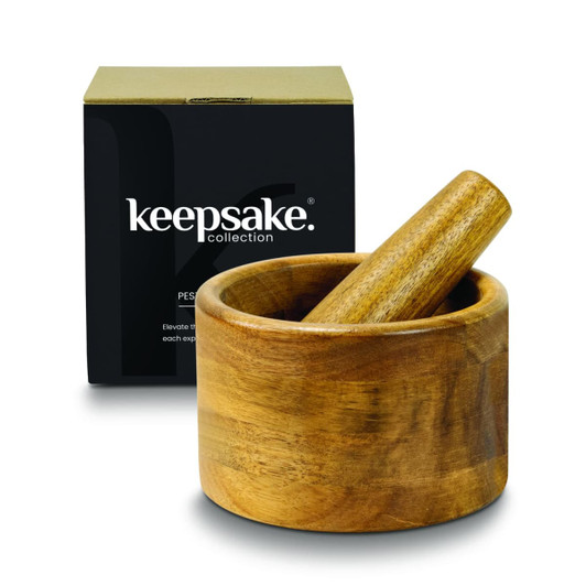 A wooden mortar and pestle set displayed beside a black box with a logo. The wood features a natural finish.