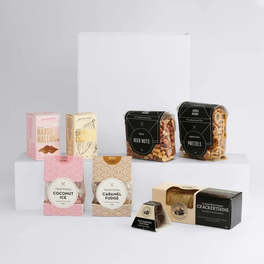 A selection of snacks including marshmallows, drink mix, beer nuts, pretzels, coconut ice, caramel fudge, and crackers, all in various packaging.
