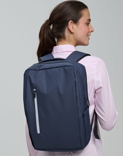 A navy blue backpack with multiple compartments and a logo, worn on the back of a person.