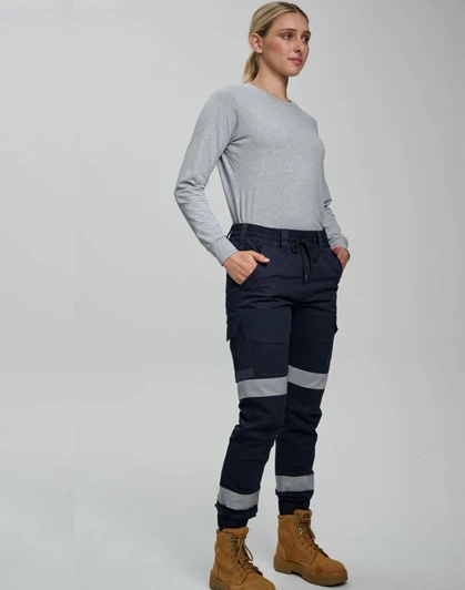 Cotton stretch drill cuffed work pants in navy with reflective tape, worn by a model with a grey long-sleeve top and boots.