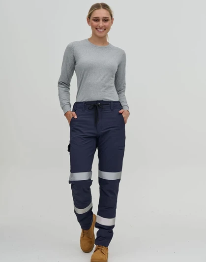 Navy water-repellent flexi work pants with reflective tape, worn by a person in a grey long-sleeve top.