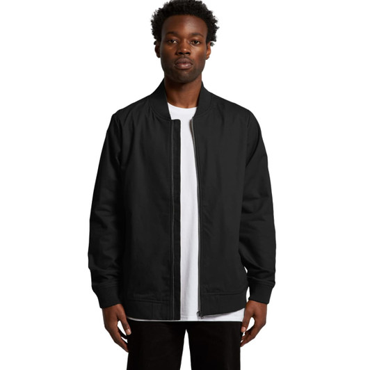 A black bomber jacket is displayed on a model, featuring a zip front and ribbed cuffs. The jacket has a logo.