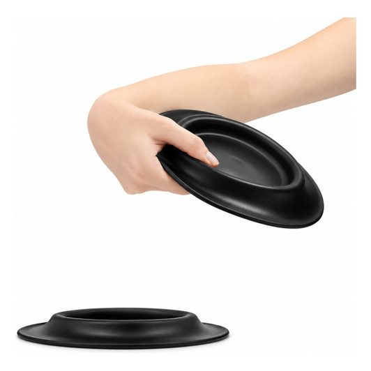 A black pet bowl with a raised edge, held by a hand. The bowl appears sleek and smooth.