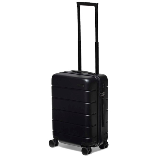 A black hardcase trolley with a telescopic handle and four wheels, featuring a logo on the front.