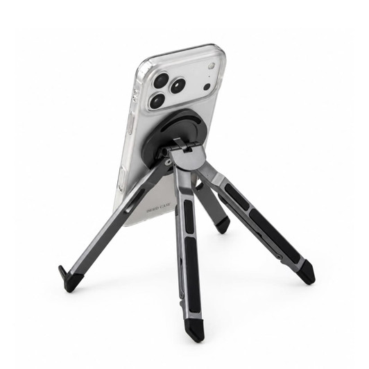 A silver and black Spider Device Stand holding a smartphone in a clear case, displaying its adjustable legs.