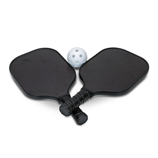 Two black pickleball paddles and a white perforated ball, arranged together. The paddles have grips and a logo.