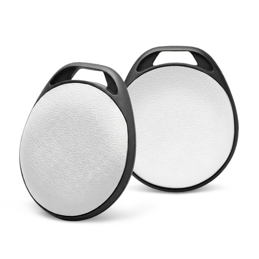 Two round Bluetooth trackers with a white circular surface and black edges, featuring a handle for easy attachment.
