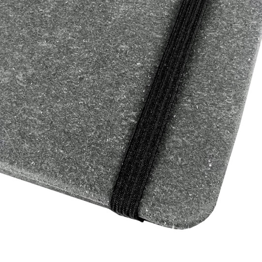 A grey notebook with a textured cover and a black elastic band closure. Features a logo on the cover.