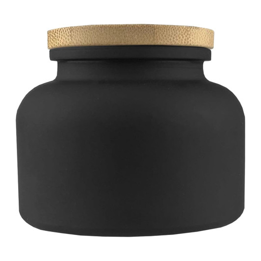 A black candle jar with a textured gold lid, featuring a round and smooth design. It has a simple, elegant appearance.
