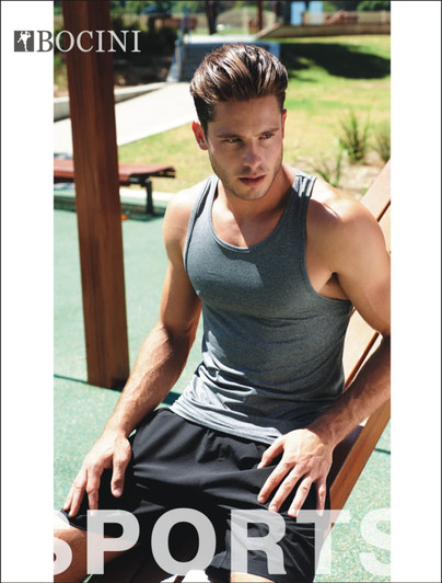 Men's woven running shorts in black, paired with a grey tank top. The model is seated outdoors, showcasing a sporty style.
