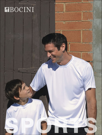 A white sublimation tee with a logo, worn by an adult and a child, standing by a brick wall.