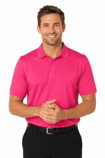 A man wearing a vibrant pink polo shirt, smiling with hands clasped, paired with black trousers. The shirt features a logo.