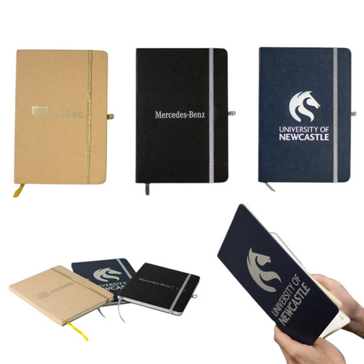A collection of A5 notebooks in various colours, including beige, navy, and black, featuring different logos.