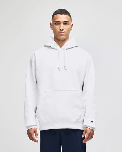 A grey hooded sweatshirt with a front pocket, featuring a logo on the sleeve, worn by a model.