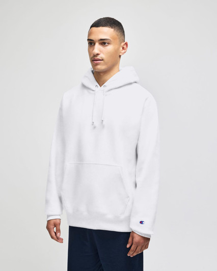 A white pullover hooded sweatshirt with a front pocket and a logo, modelled by a person.