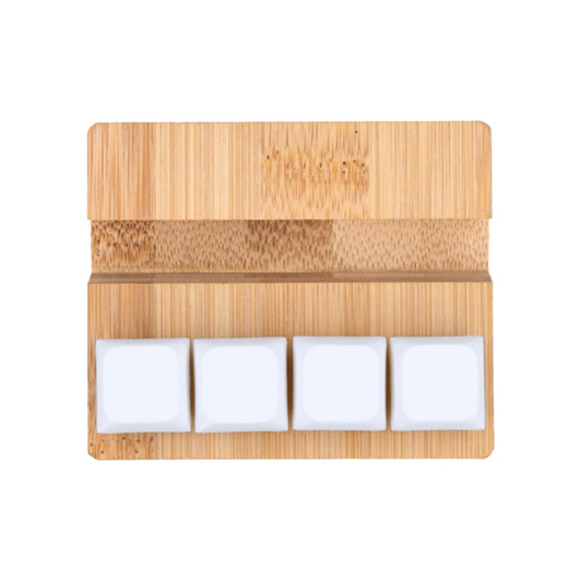 A bamboo stand featuring three white square stress reliever blocks on a smooth surface.