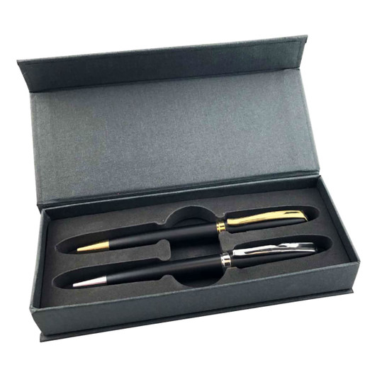 A black and gold metal pen gift set displayed in a grey box, featuring two pens with a logo.