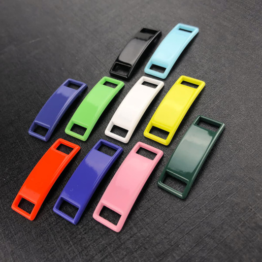 A set of classic shoelace charms in various colours: black, blue, green, white, yellow, pink, purple, red, and dark green.