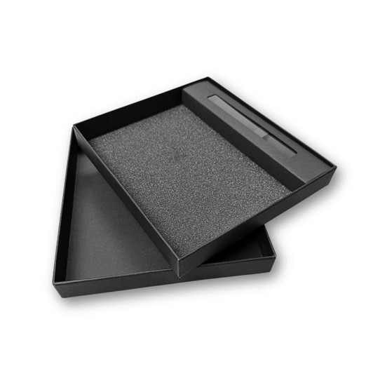 A black notebook gift set box with a foam insert and a sleeve for a pen, featuring a logo.