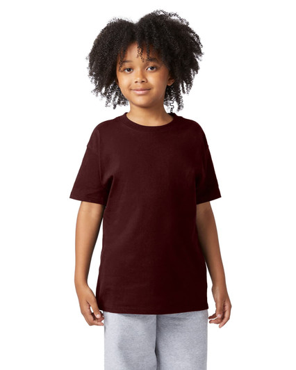 A young person wears a maroon short sleeve t-shirt with a simple design and a logo on the sleeve.