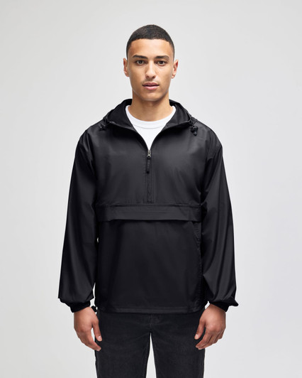 A black packable anorak jacket with a hood, featuring a front zip and a logo. Model is standing against a plain background.