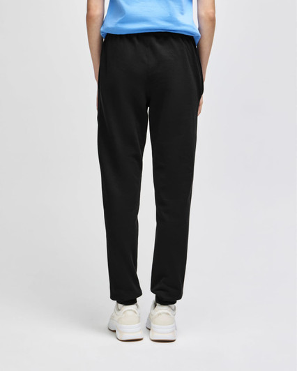 Adult fleece joggers in dark grey, featuring an elastic waistband and a logo. Model shown from the back.