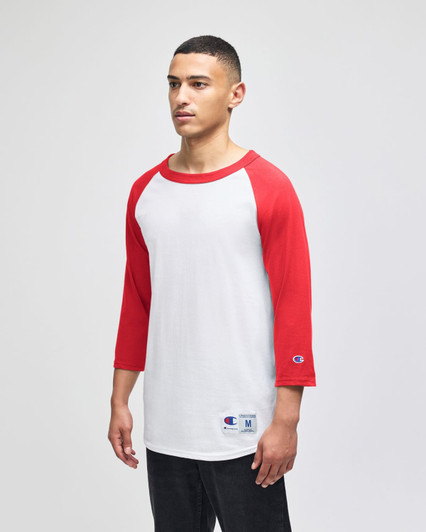 A white and red raglan baseball T-shirt with three-quarter sleeves, featuring a logo on the hem.