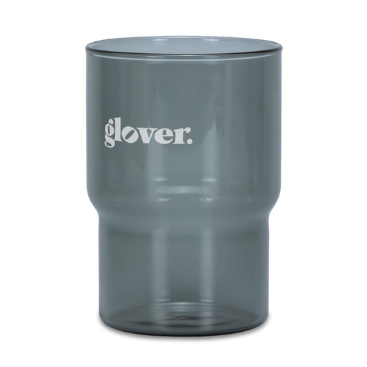 A drink tumbler in a smoky grey colour with a logo. Features a modern design suitable for various beverages.