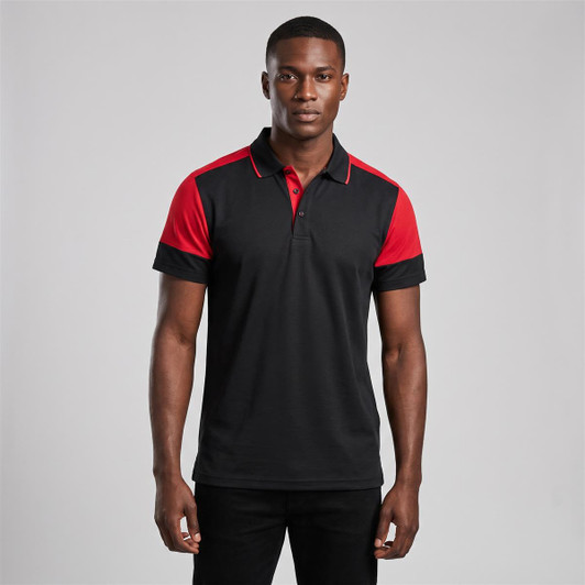 A black polo shirt with red shoulder accents, featuring a collar and short sleeves, displayed on a model.