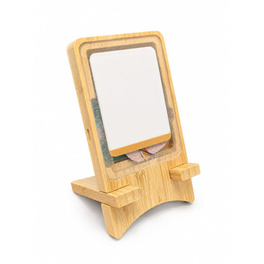 A wooden stand with a clear front, showcasing a notepad and a colourful ribbon inside.