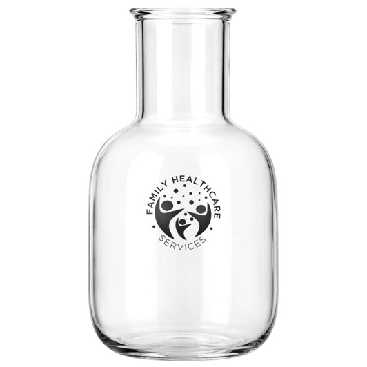 A glass carafe with a round body and a narrow neck, featuring a logo. Clear in colour.