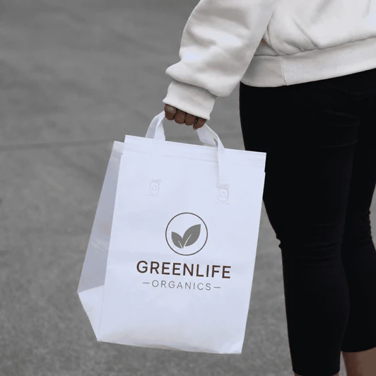 A white insulated reusable bag with two handles, featuring a logo on the front.