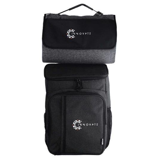A black and grey picnic backpack featuring a logo, with a detachable insulated cooler on top.