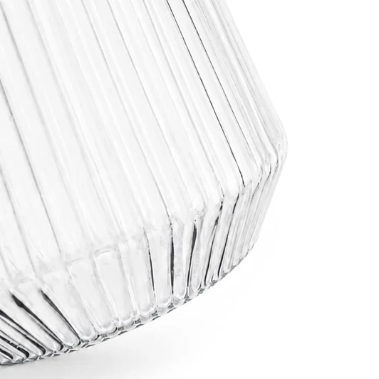 A clear glass tumbler with a ribbed design, featuring a tapered shape and a smooth finish.