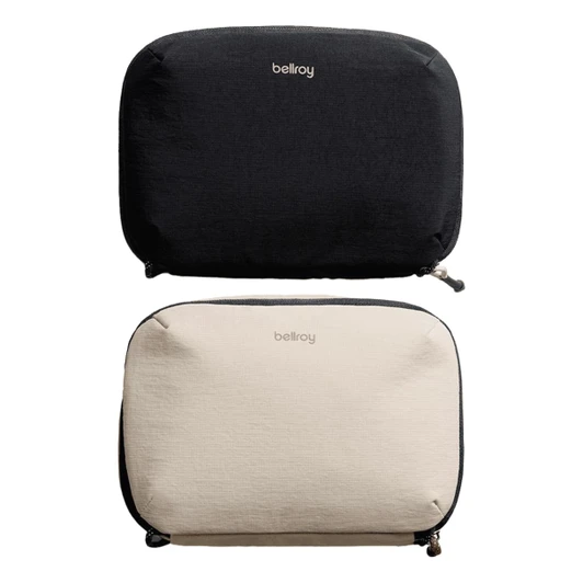 A black and a beige tech kit with zippers, both featuring a logo on the front.