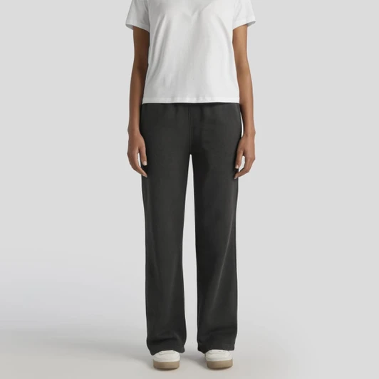 Cuffless track pants in a faded black colour, paired with a plain white t-shirt and casual footwear.
