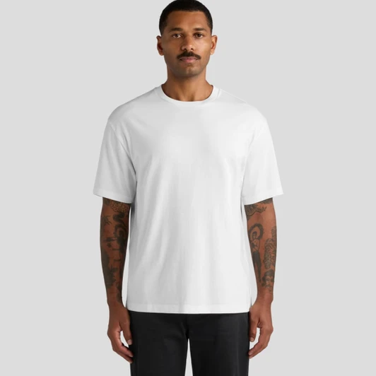 A white unisex tee featuring a relaxed fit and a minor logo. The model stands against a neutral background.