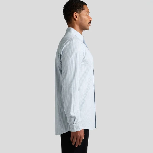 A button-up Oxford stripe shirt in light blue and white, featuring a collar and long sleeves, with a logo present.
