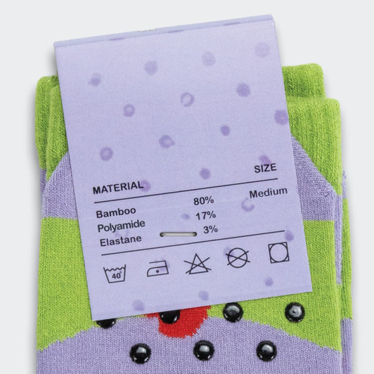 A pair of colourful knitted socks in green and purple, featuring a tag with material details and care instructions.