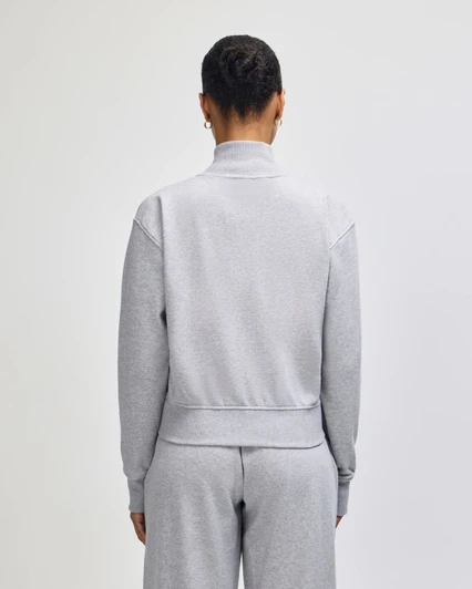 A grey French Terry women's full-zip jacket, viewed from the back, featuring a simple design and no visible branding.