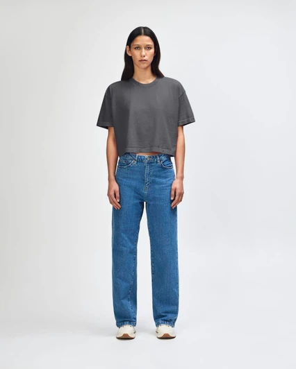 A grey heavy cotton crop boxy T-shirt worn with blue jeans, featuring a relaxed fit and short sleeves.