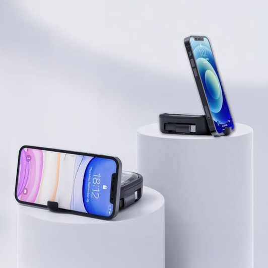 A mobile phone stand in black, holding a smartphone, displayed on white pedestals against a light background.
