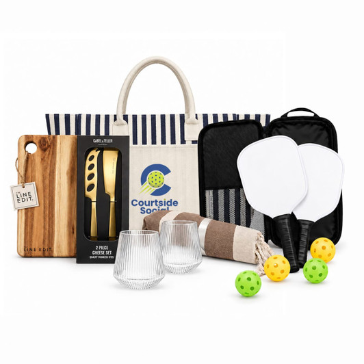 A tote bag with a striped design, a cutting board, glassware, paddles, and yellow balls. A product logo is present.