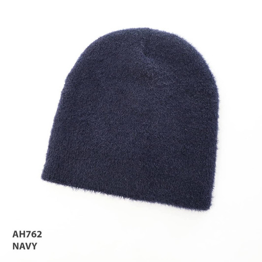A navy blue shaggy beanie with a soft texture, featuring a logo.