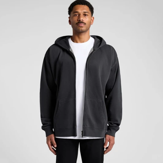 A person wearing a black zip-up hoodie with a front zip and an attached hood, featuring a logo.