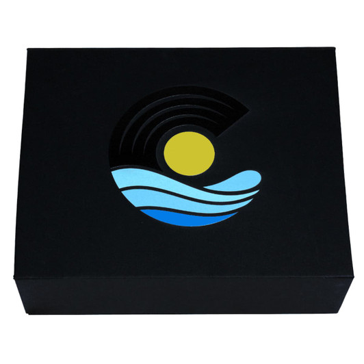 A black magnetic gift box featuring a colourful logo with a sun, waves, and circular patterns in blue and yellow.